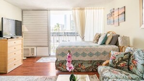 A bedroom with a bed, a sofa, a TV, a dresser, and a window with curtains. - 8 GUESTS, 2 X ❤️AWESOME STUDIOS❤️ FREE PARKING, 5MIN TO OCEAN (Honolulu)