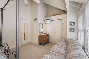 A bedroom with a bed, a dresser, a television on the wall, and a window with blinds. - 180 Degrees by Taylor Made Deep Creek (Oakland)