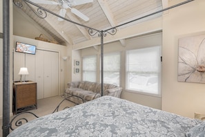 A bedroom with a bed, a sofa, a TV, and a ceiling fan. - 180 Degrees by Taylor Made Deep Creek (Oakland)