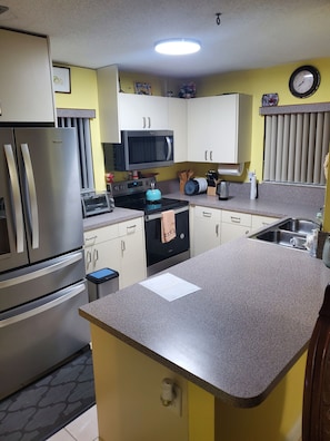 Fridge, microwave, stovetop, coffee/tea maker