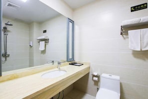 A bathroom with a sink, mirror, towel rack, and toilet. - Jiaxi Hotel (Tongliao)