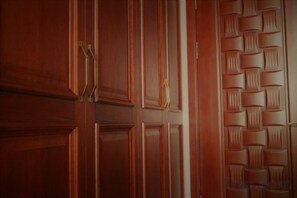 A wooden door with a textured panel design. - Jiaxi Hotel (Tongliao)