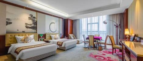 A hotel room with two beds, a desk, a chair, a dining table, and a large window.