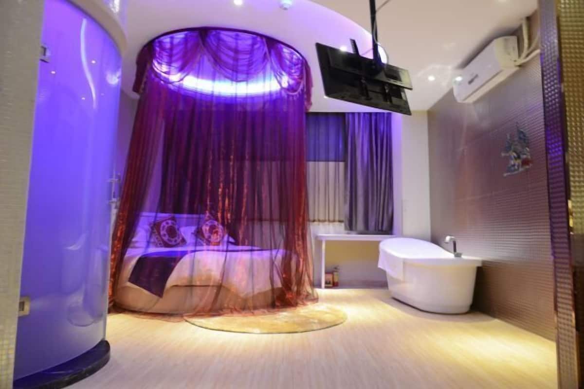 A modern bathroom with a bathtub, a shower area, and a vanity.