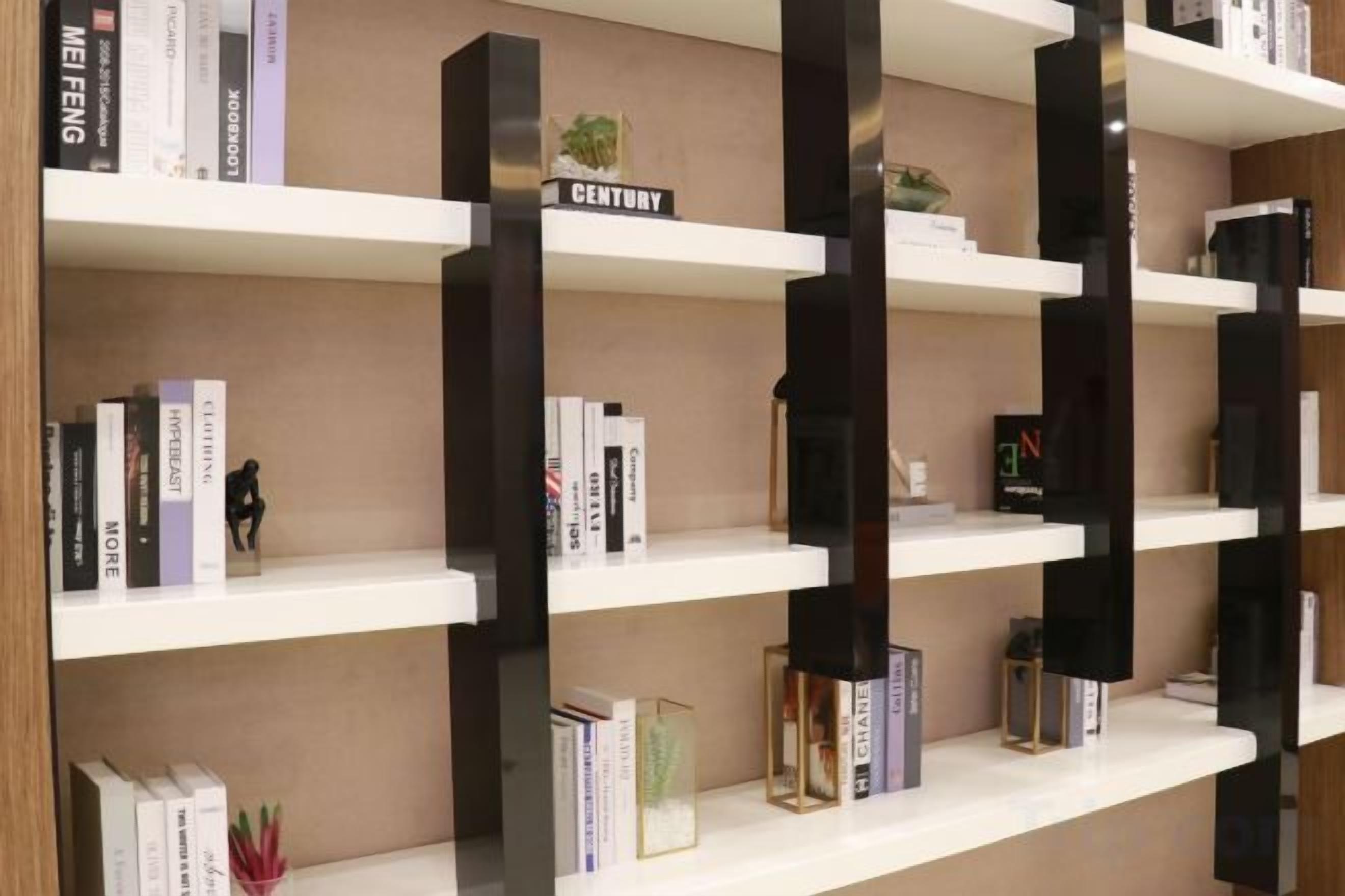 A bookshelf with multiple shelves, some with books and decorative items.