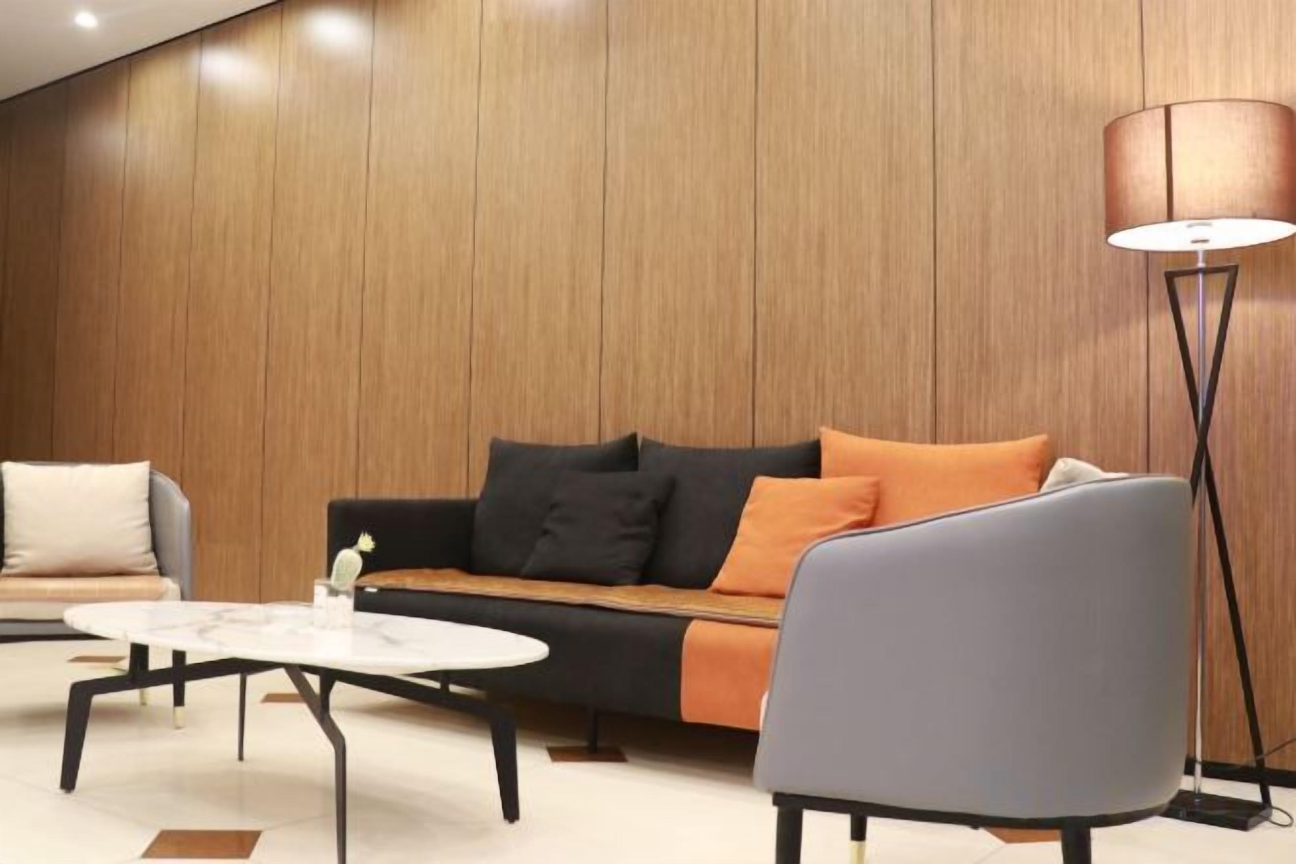 A modern living room with a sofa, armchair, and coffee table.