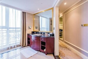 A modern bathroom with a large mirror, dark wood vanity, and a glass shower enclosure. - Howard Johnson Junhe Hotel Beijing (Beijing)