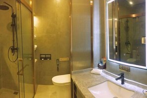 A modern bathroom with a glass-enclosed shower, a toilet, and a sink with a large mirror. - Villa Lido (Laiyang)