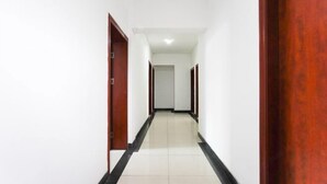 A hallway with white walls and a tiled floor. - Cangzhou Innovation Hotel (Cangzhou West Railway Station Star School Branch) (Chenzhou)