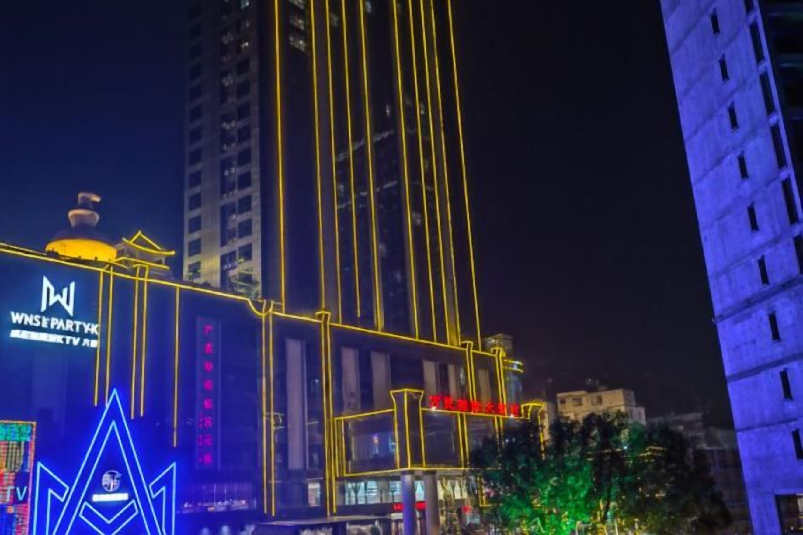 A building with illuminated signage and vertical lines.