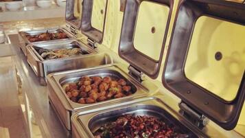 A buffet with multiple food stations, each with a metal container and a lid.