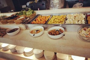 A buffet with various food items and bowls of different dishes. - Roman Garden Business Center (Mudanjiang)
