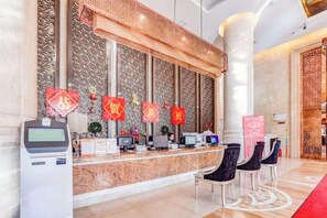 A reception area with a marble counter, several computer monitors, and a digital kiosk. - Roman Garden Business Center (Mudanjiang)