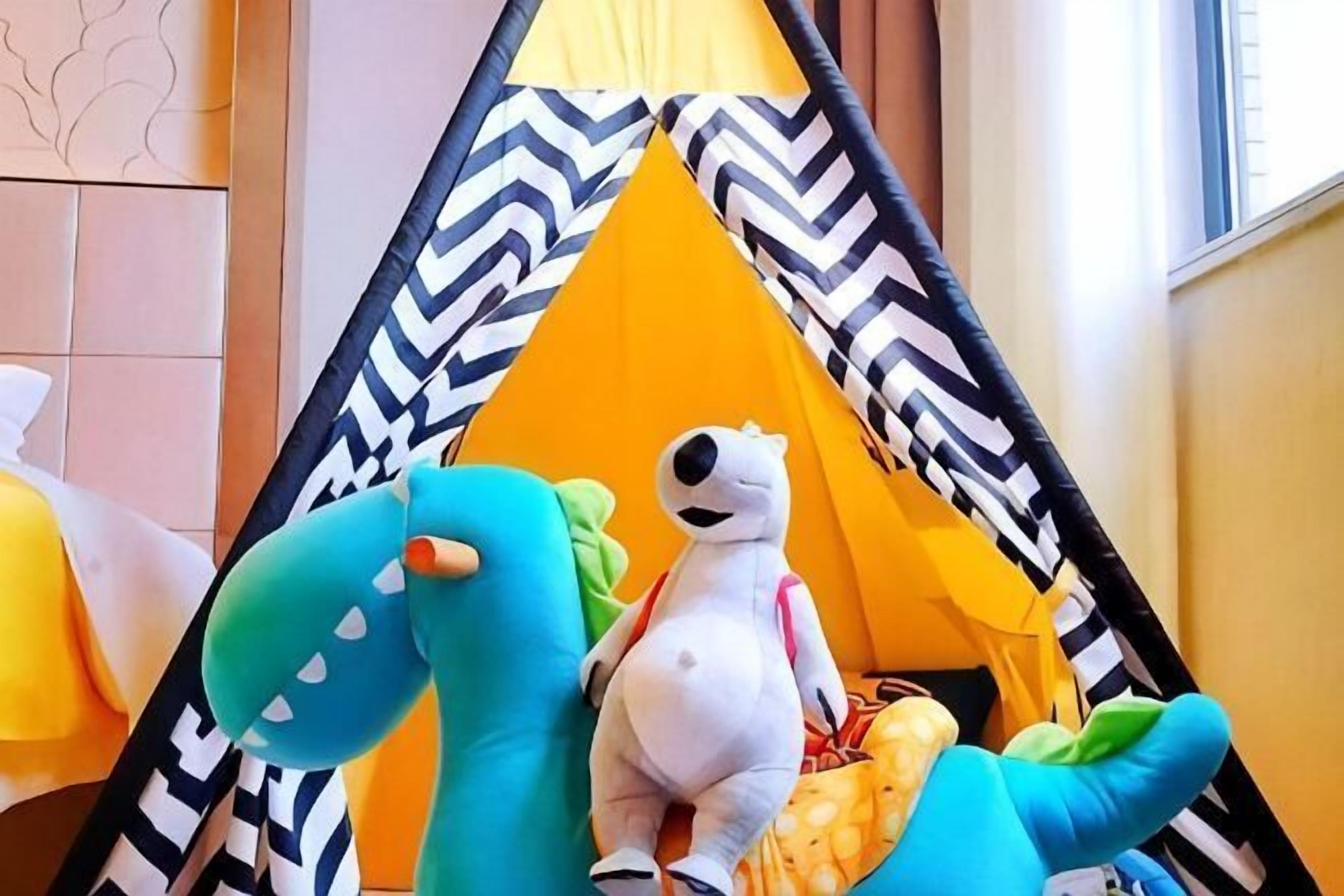 A tent-like structure with a plush toy and a stuffed animal inside.