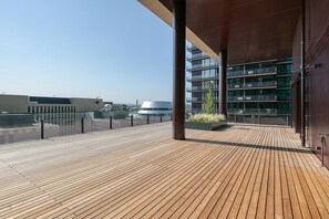 Enjoy panoramic views from the rooftop deck with a glass railing and vertical columns.