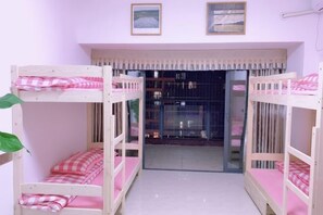 A room with bunk beds, a window with curtains, and framed pictures on the wall. - Free Space Youth Hostel (Zhanjiang)