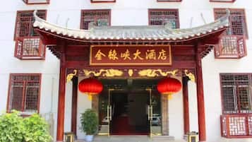 A traditional Chinese building with a tiled roof and red lanterns.