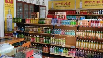 A store with shelves stocked with various bottled beverages.