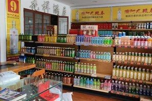 A store with shelves stocked with various bottled beverages. - Jin'an Hotel (Zhangye)