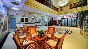 A lobby with a reception desk, seating area, and a staircase. - Jin'an Hotel (Zhangye)