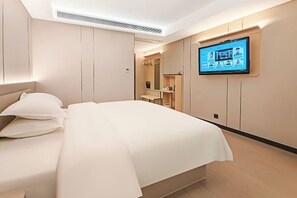 A modern hotel room with a bed, a television mounted on the wall, and a built-in wardrobe. - Guanbeiding Hotel (Nan'an)