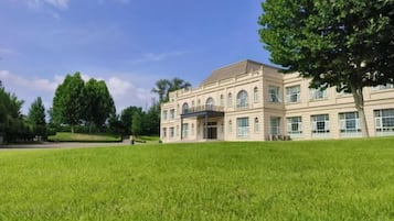 A large building with a symmetrical facade, multiple windows, and a central entrance.