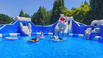An inflatable water park with slides and pools.