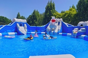 An inflatable water park with slides and pools.