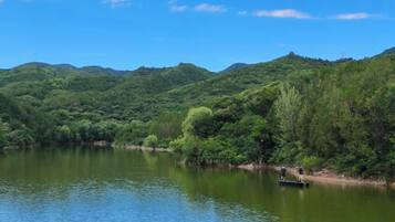 A calm lake surrounded by lush green hills.
