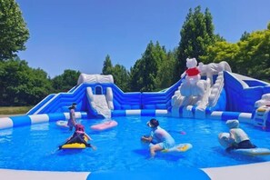 An inflatable pool with slides and a small platform. - Renji Hotel (Beijing)