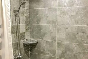 A shower with a handheld showerhead and a wall-mounted faucet. - Nanxun Kangyu Yashe Inn (Huzhou)
