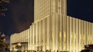 A large, multi-story building with a grid-like facade, likely a hotel or office building. - Xi Le Hui Hotel (Fujin)