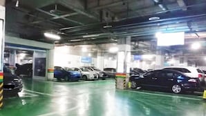 A multi-level parking garage with several cars parked. - Shengkai Business Hotel (Chongqing)