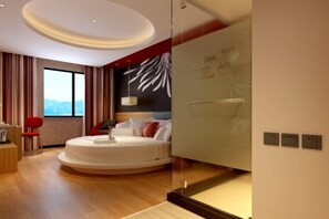 A modern bedroom with a circular bed, a desk, and a large window. - Thank You Inn Shenzhen Longgang Pingdi Tongxin (Shenzhen)