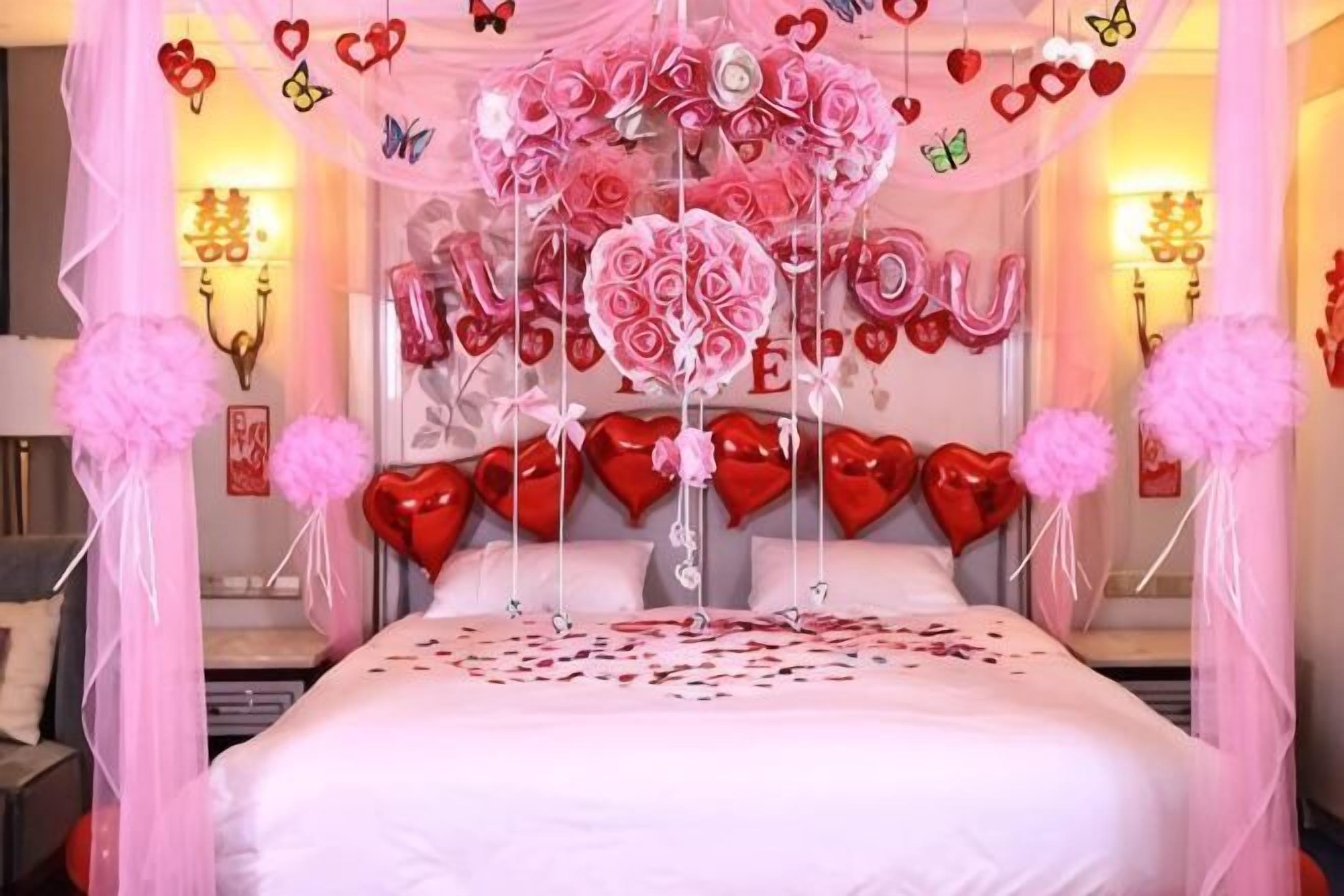A bed with a canopy, heart-shaped decorations, and a wall with a heart-shaped design.