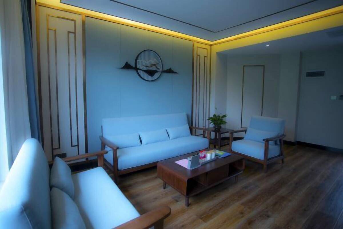 A modern living room with a sofa, armchairs, and a coffee table.