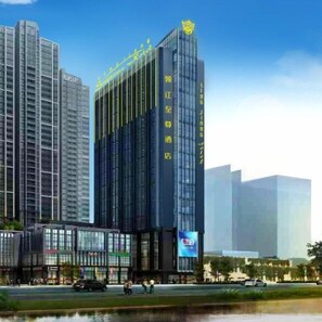 A modern high-rise building with a prominent logo at the top, surrounded by other tall buildings. - Ling Jiang Hotel (Yongtai)