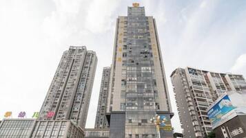 A high-rise building with multiple floors, large windows, and a prominent entrance at the base.
