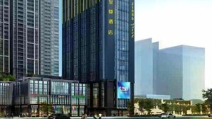 A modern high-rise building with a prominent logo at the top. - Ling Jiang Hotel (Yongtai)
