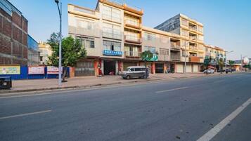 A multi-story building with commercial establishments on the ground floor.