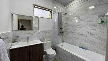 Combined shower/tub, hair dryer, towels, soap
