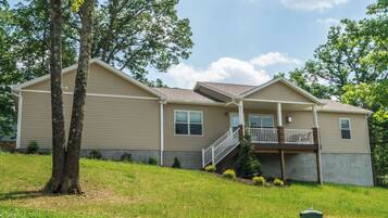 A two-story house with a covered front porch and a small front yard.