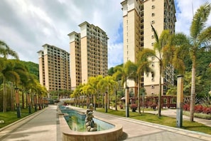 A residential complex with high-rise buildings, a swimming pool, and well-maintained greenery. - Coconut Maple Home Apartment (Wuzhishan)