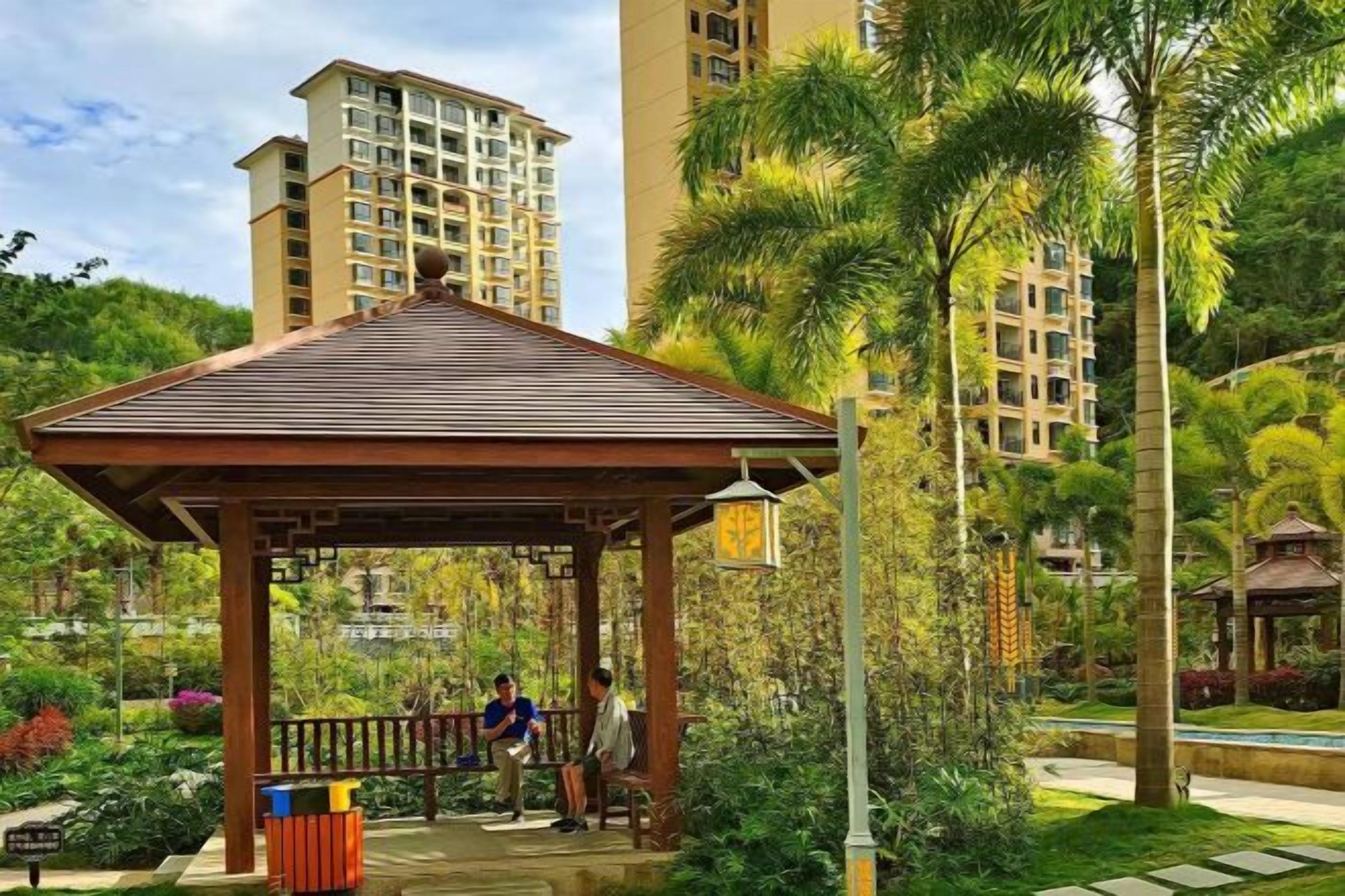 A gazebo in a park with a building in the background.