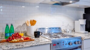 A modern kitchen with white subway tiles, stainless steel appliances, and a granite countertop. - Date me ,Top Location , Close Beach  (Greenacres)