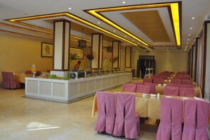 A hotel lobby with a reception desk, seating area, and a large window. - Chaxiang Hotel (Ning'er)
