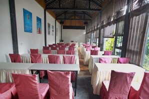 A conference room with tables and chairs, large windows, and a high ceiling. - Chaxiang Hotel (Ning'er)