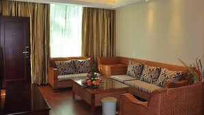 A living room with two sofas, a coffee table, and a TV. - Chaxiang Hotel (Ning'er)