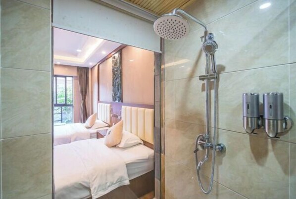 A hotel room with a shower, a bed, and a view of the outdoors.