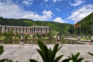 Situated in a lush valley, this building offers a serene escape with a flat roof and beautifully maintained surroundings.